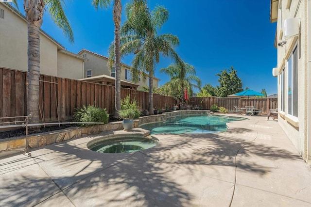 view of pool with an in ground hot tub and a patio area