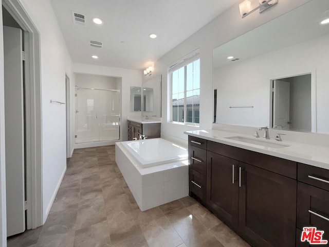 bathroom with separate shower and tub and vanity