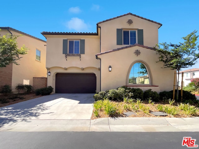 mediterranean / spanish-style house featuring a garage