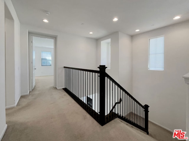 hall featuring light colored carpet