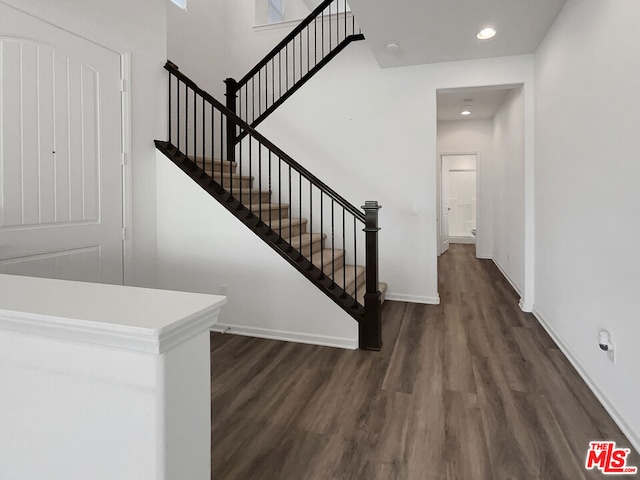 stairway featuring hardwood / wood-style flooring