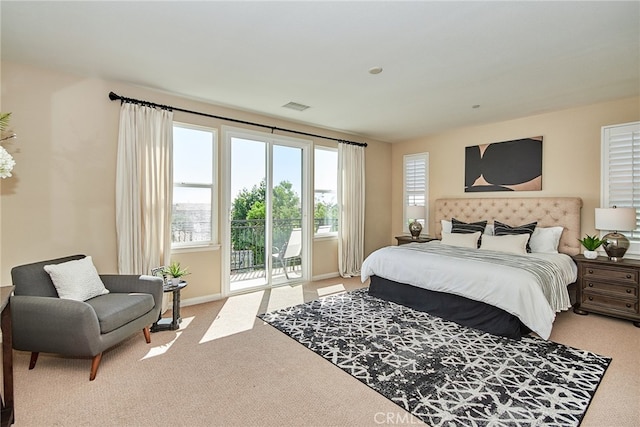 carpeted bedroom featuring access to outside