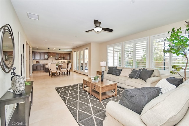 living room featuring ceiling fan and light tile patterned flooring