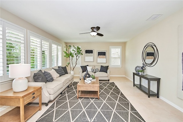 tiled living room featuring ceiling fan