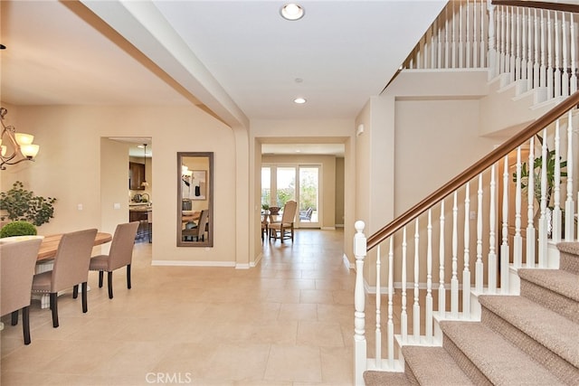 foyer entrance featuring light tile patterned flooring and a chandelier