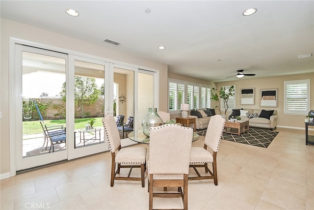 tiled dining area with ceiling fan