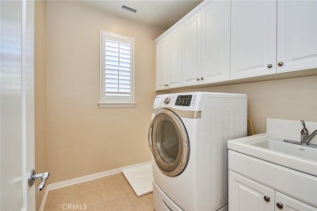 laundry area featuring cabinets, washer / clothes dryer, light tile patterned flooring, and sink