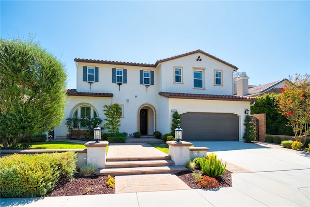 mediterranean / spanish house with a garage