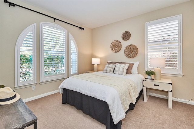 bedroom featuring light colored carpet