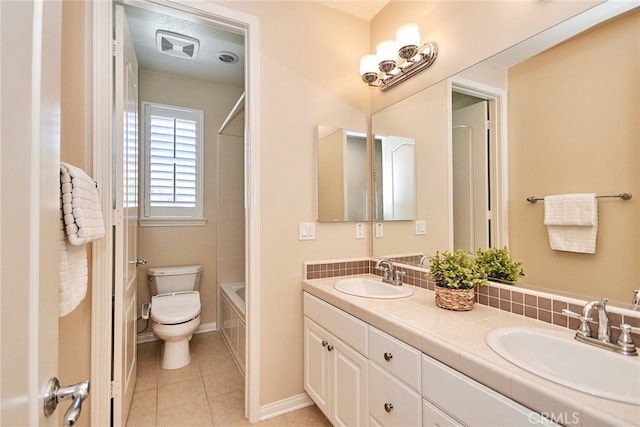 full bathroom featuring washtub / shower combination, vanity, toilet, and tile patterned floors