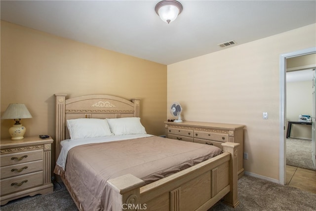 bedroom with dark colored carpet