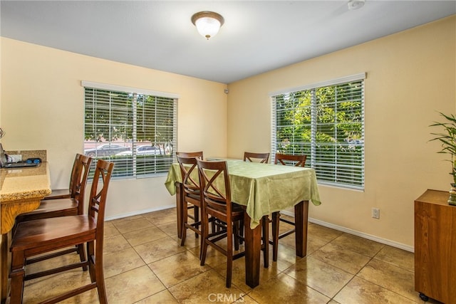 tiled dining space featuring a wealth of natural light