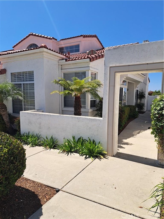 3310 Tripoli Way, Oceanside, CA 92056 - view of front of home with stucco siding, a fenced front yard, and a tiled roof