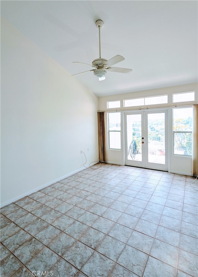 tiled empty room with ceiling fan and french doors