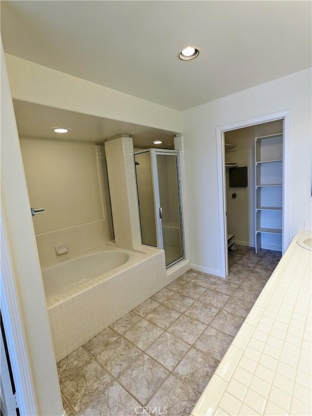3310 Tripoli Way, Oceanside, CA 92056 - bathroom featuring a spacious closet, a garden tub, a stall shower, recessed lighting, and tile patterned floors