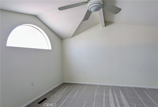 carpeted empty room featuring lofted ceiling with beams and ceiling fan