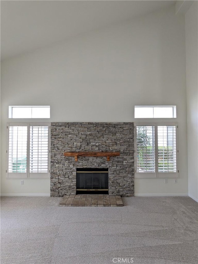 3310 Tripoli Way, Oceanside, CA 92056 - unfurnished living room with baseboards, a stone fireplace, carpet floors, and a high ceiling