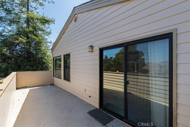 view of property exterior with a patio area