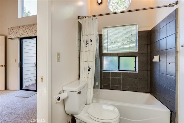 bathroom featuring shower / tub combo and toilet