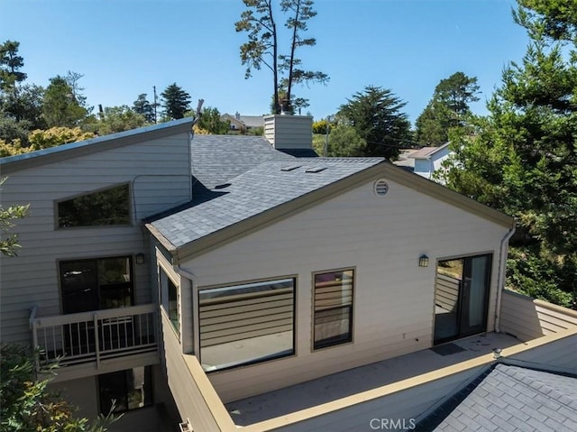 1550 Pineridge Dr, Cambria, CA 93428 - back of house featuring roof with shingles and a chimney