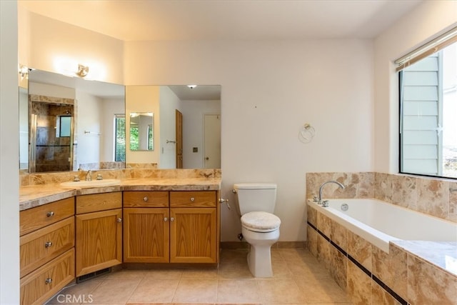 bathroom featuring tiled tub, plenty of natural light, and toilet