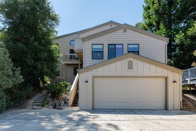 1550 Pineridge Dr, Cambria, CA 93428 - view of front facade with a garage, board and batten siding, driveway, and stairway
