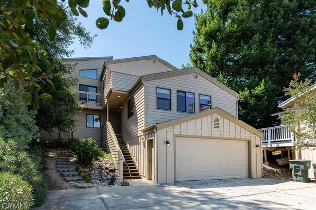 1550 Pineridge Dr, Cambria, CA 93428 - view of front of house featuring board and batten siding, concrete driveway, and stairway