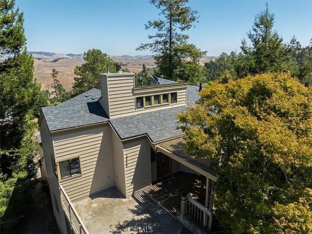 rear view of house featuring a mountain view