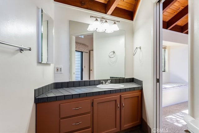 bathroom featuring wood ceiling, lofted ceiling with beams, and vanity