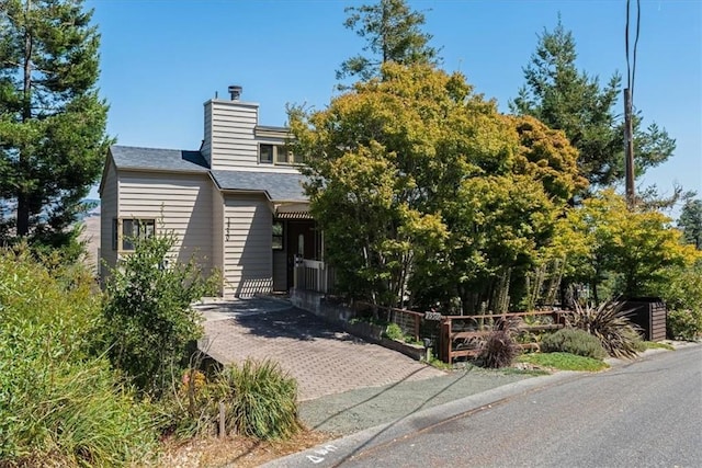 1550 Pineridge Dr, Cambria, CA 93428 - view of front of house with roof with shingles, fence, and a chimney