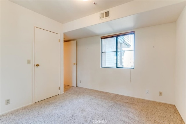 empty room featuring light colored carpet