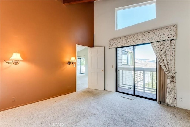 1550 Pineridge Dr, Cambria, CA 93428 - carpeted empty room with a towering ceiling and a healthy amount of sunlight