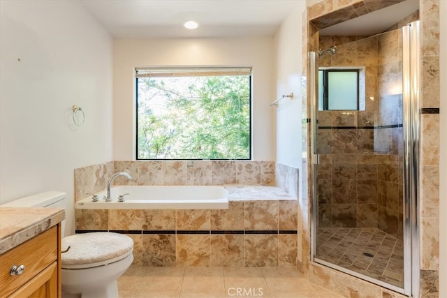 full bathroom featuring vanity, tile patterned flooring, toilet, and separate shower and tub