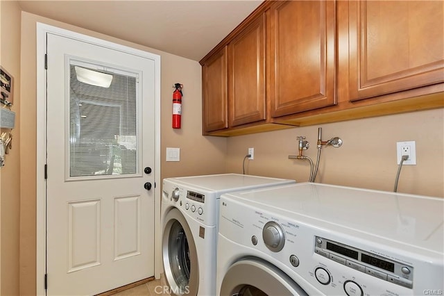 laundry room with cabinets and washer and dryer