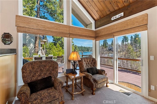 sunroom / solarium featuring a healthy amount of sunlight, wood ceiling, lofted ceiling, and a water view