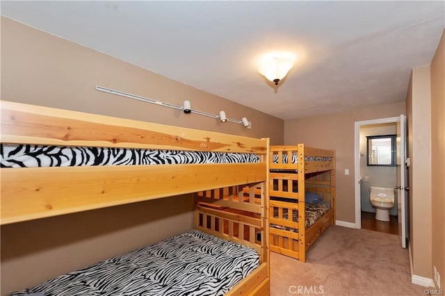 carpeted bedroom featuring ensuite bath