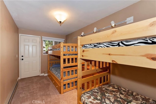 carpeted bedroom featuring a baseboard heating unit