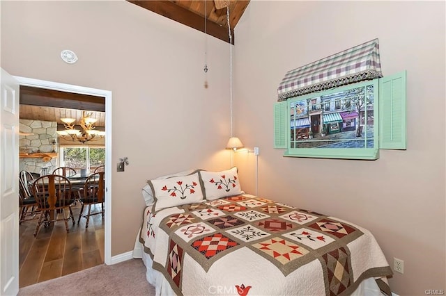 bedroom with wood ceiling, vaulted ceiling with beams, and hardwood / wood-style floors