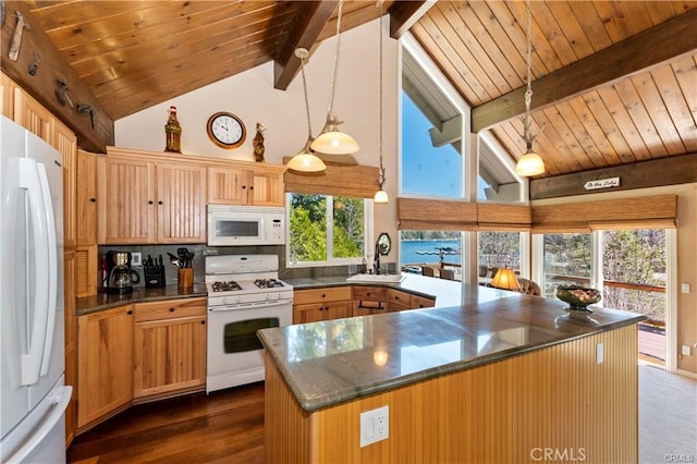 kitchen with pendant lighting, beam ceiling, white appliances, and a healthy amount of sunlight