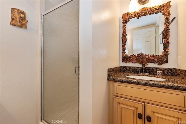 bathroom with walk in shower and vanity