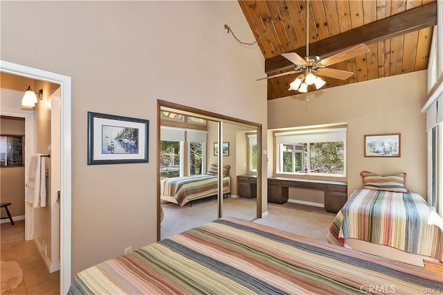 carpeted bedroom with wood ceiling, a closet, high vaulted ceiling, and ceiling fan