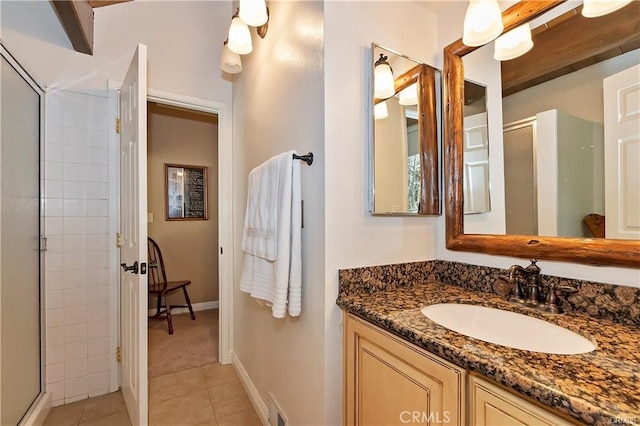 bathroom with vanity, tile patterned floors, and a shower with shower door