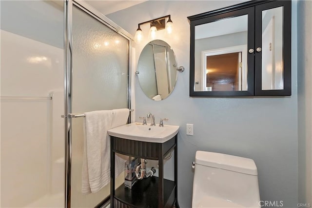 bathroom featuring sink, toilet, and a shower with door