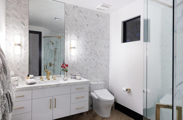 bathroom with walk in shower, vanity, hardwood / wood-style flooring, tile walls, and toilet