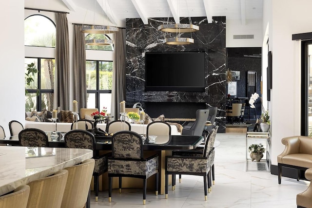 dining area with beamed ceiling, a towering ceiling, tile walls, and wood ceiling