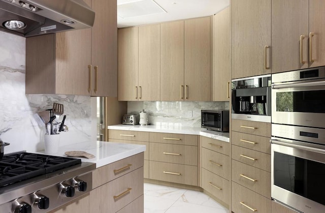 kitchen with light brown cabinets, stainless steel appliances, range hood, and tasteful backsplash