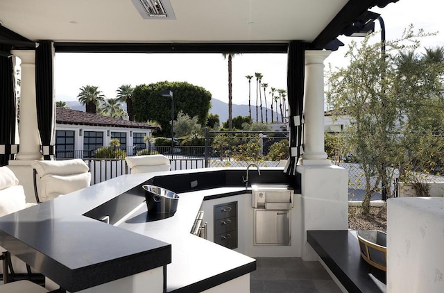 view of patio / terrace with a mountain view and area for grilling