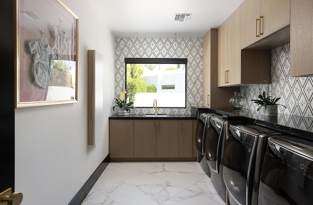 laundry room with cabinets, sink, and washing machine and clothes dryer