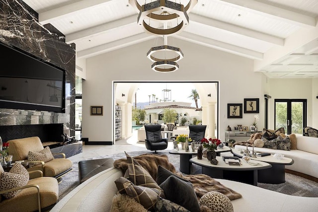 living room featuring lofted ceiling with beams, wood ceiling, a fireplace, and french doors