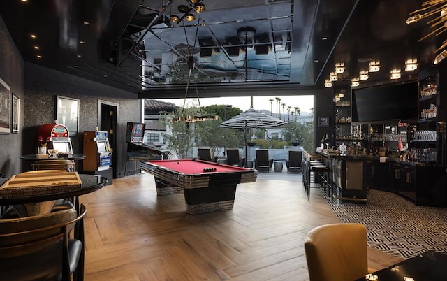 game room featuring parquet floors, a towering ceiling, bar, and billiards